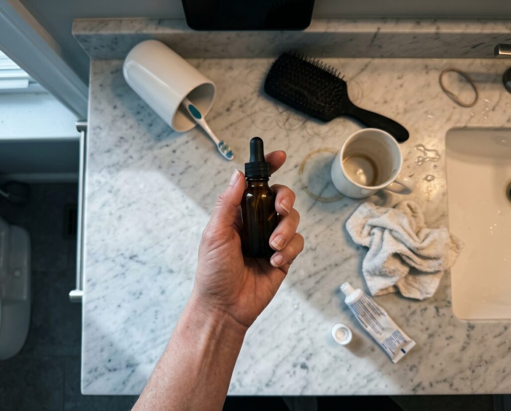 Bathroom counter — Kinfolk documentary (hand-only, no face)